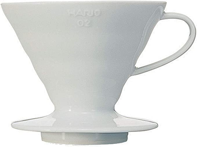 Hario v60 is a white ceramic material and shaped in a cone with a small handle and a lip wide enough to fit on a coffee cup or carafe.