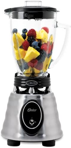 Oster Blender has a sturdy silver base that looks heavy and a glass pitcher on top with a black plastic lid.